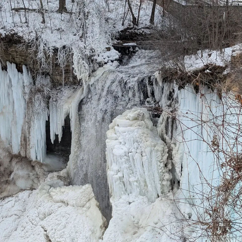 A frozen waterfall hung with huge icicles